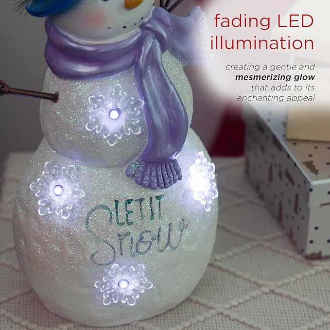 Alpine Corporation 14”H Lavender Winter "Let It Snow" Snowman Statue with Fading LED Lights, Christmas Decor